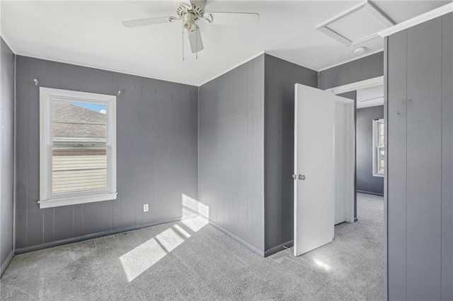 carpeted empty room featuring ceiling fan