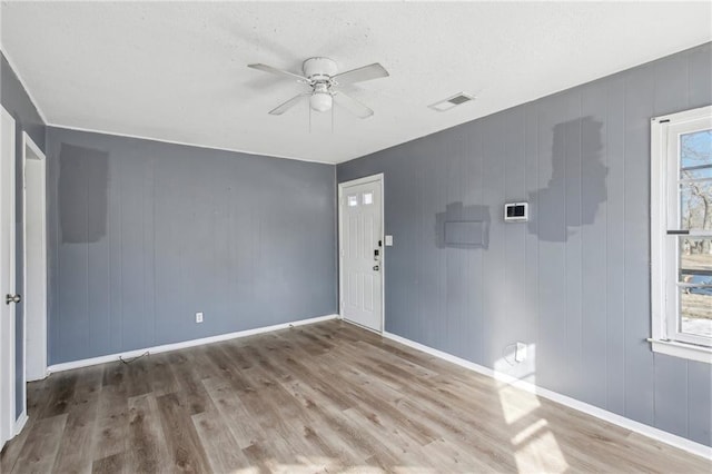 unfurnished room featuring hardwood / wood-style flooring and ceiling fan