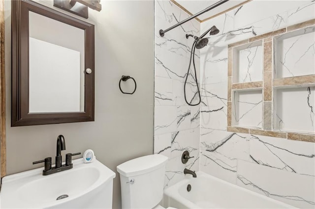 full bathroom with sink, toilet, and tiled shower / bath