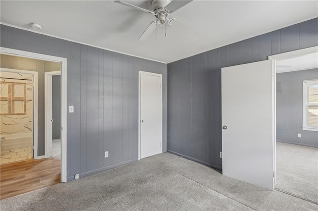 unfurnished bedroom featuring light carpet, ceiling fan, and a closet