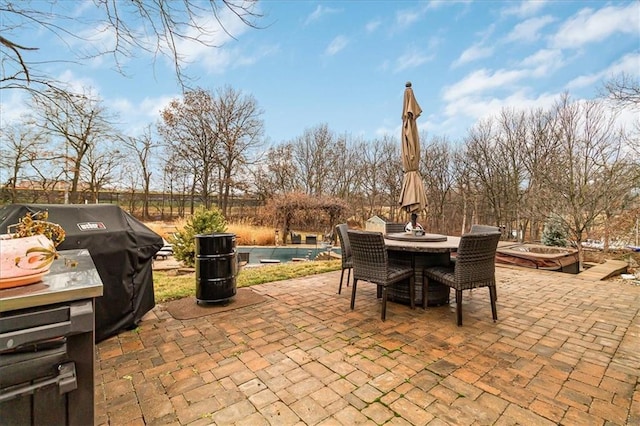 view of patio featuring a swimming pool and grilling area