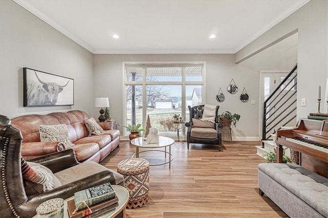 living room with crown molding and light hardwood / wood-style floors