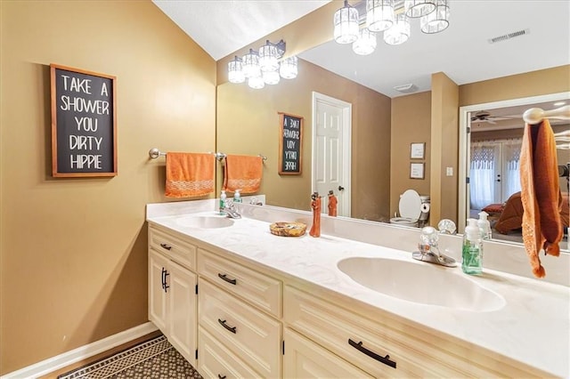 bathroom with vanity, vaulted ceiling, and toilet