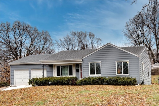 ranch-style house with a garage and a front lawn