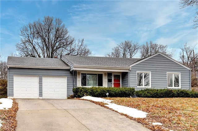 single story home featuring driveway, roof with shingles, and an attached garage