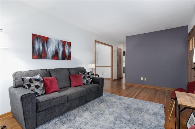 living area featuring baseboards and wood finished floors