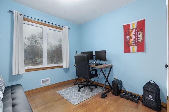 office featuring visible vents and wood finished floors