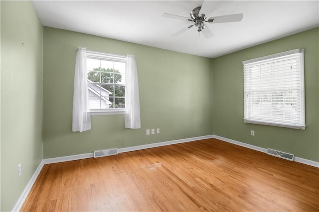 empty room featuring hardwood / wood-style flooring and ceiling fan