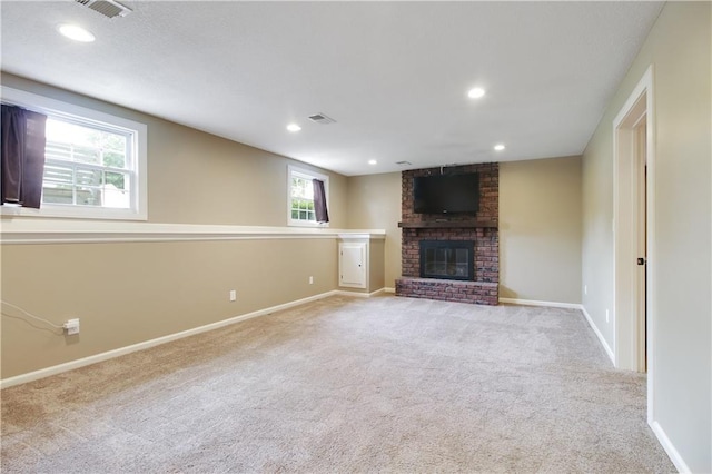 unfurnished living room featuring light colored carpet and a fireplace