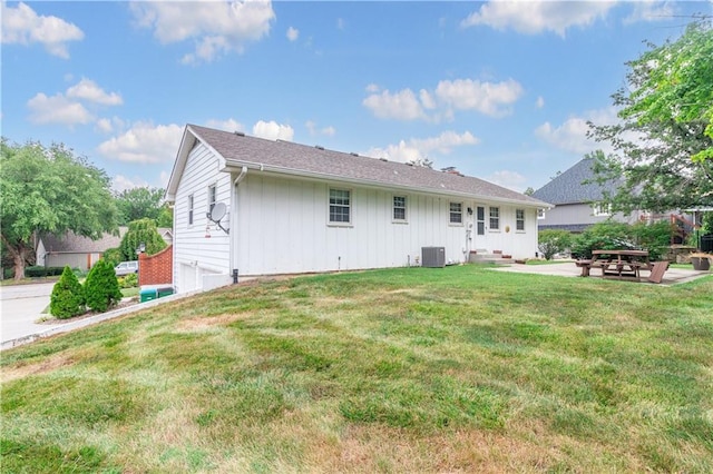 back of house with a lawn, a patio, and central air condition unit