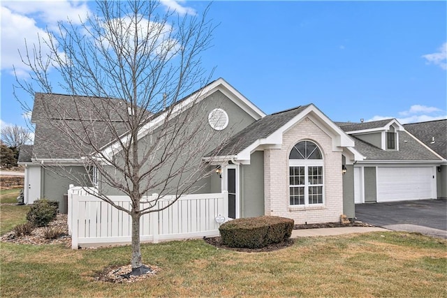 view of front of property featuring a garage and a front yard