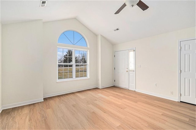 empty room featuring ceiling fan, vaulted ceiling, and light hardwood / wood-style flooring