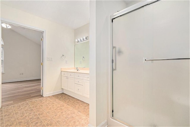 bathroom featuring walk in shower and vanity