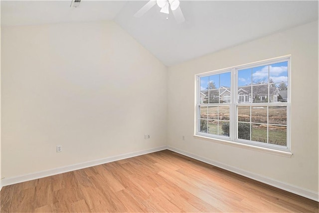 empty room featuring vaulted ceiling, ceiling fan, and light wood-type flooring