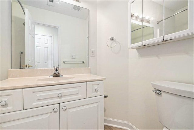 bathroom featuring vanity and toilet