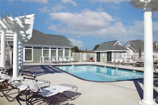 view of pool featuring an outdoor structure, a pergola, and a patio area