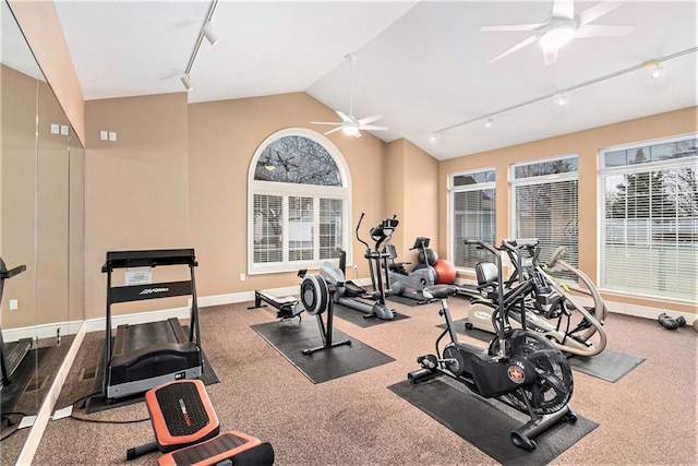 exercise room with vaulted ceiling, rail lighting, and ceiling fan