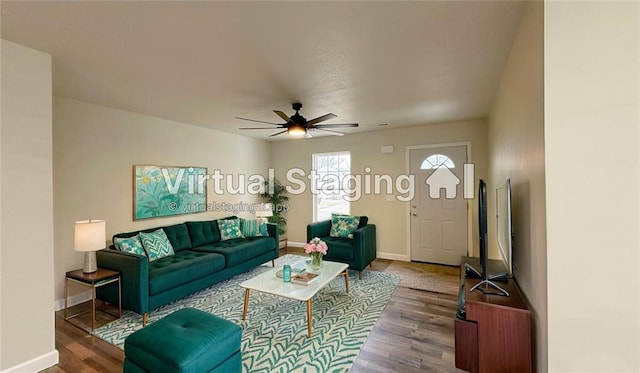 living room featuring hardwood / wood-style floors and ceiling fan