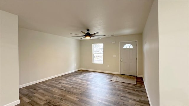 entryway with dark wood-type flooring and ceiling fan