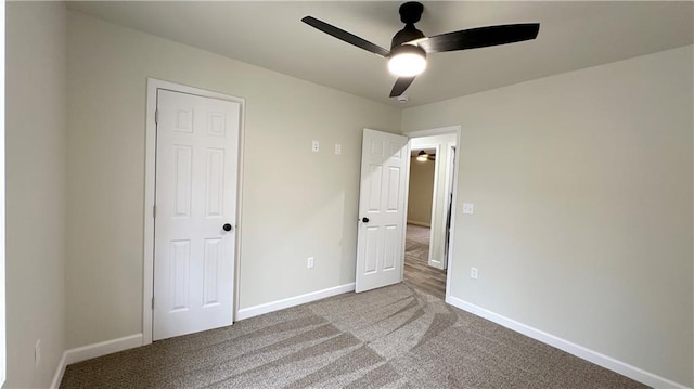 unfurnished bedroom featuring ceiling fan and carpet flooring