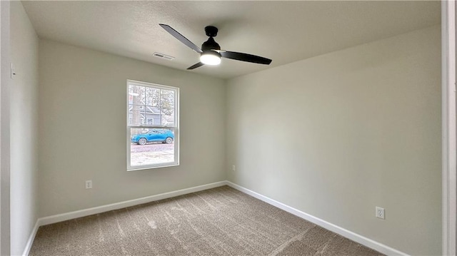 spare room with carpet and ceiling fan