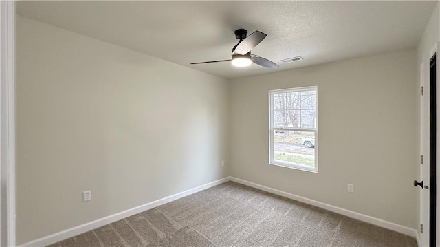 spare room featuring ceiling fan and carpet floors