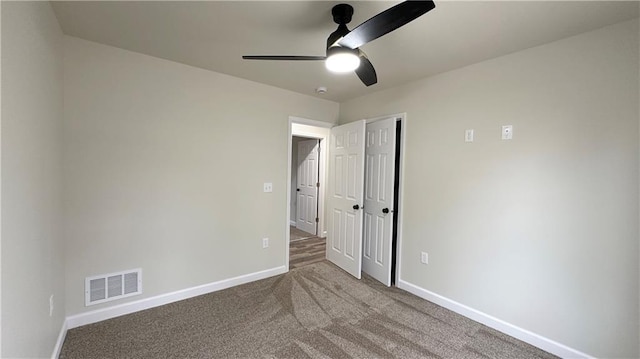 unfurnished bedroom featuring carpet flooring, ceiling fan, and a closet