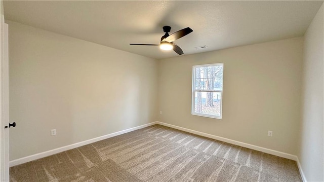 carpeted spare room with ceiling fan