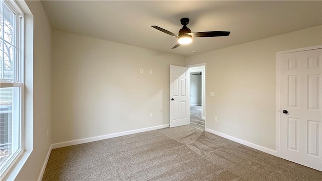 unfurnished bedroom with ceiling fan and light carpet