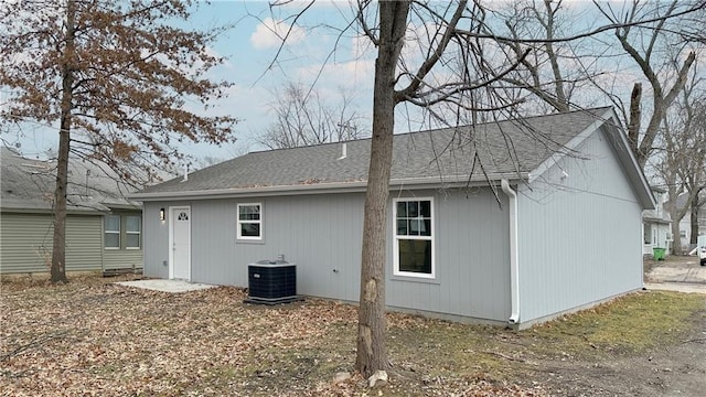 rear view of property with central AC