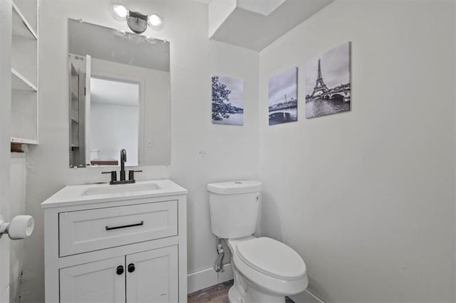 7901 Hedges Ave, Raytown, MO 64138 - bathroom featuring baseboards, toilet, and vanity