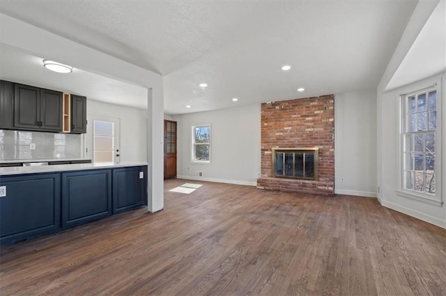 7901 Hedges Ave, Raytown, MO 64138 - kitchen featuring light countertops, dark wood-style floors, and baseboards