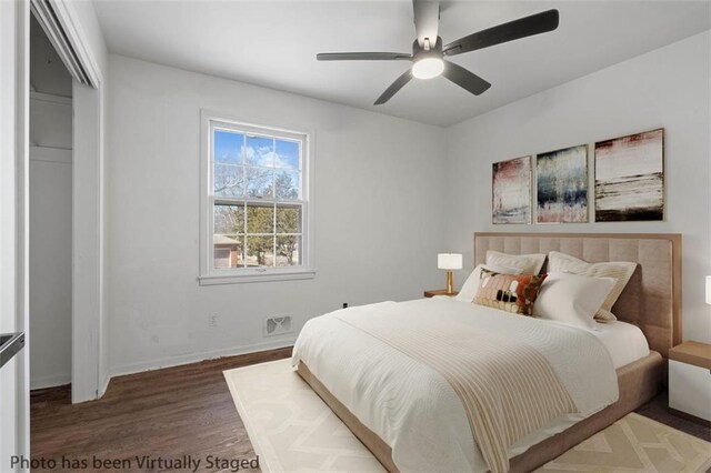 7901 Hedges Ave, Raytown, MO 64138 - bedroom with baseboards, wood finished floors, and a ceiling fan
