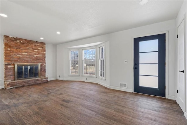7901 Hedges Ave, Raytown, MO 64138 - unfurnished living room featuring visible vents, a textured ceiling, wood finished floors, recessed lighting, and baseboards