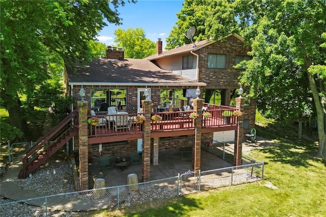 back of property featuring a yard, a deck, and a patio