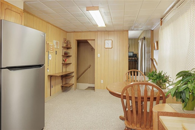 dining space featuring baseboards and light colored carpet