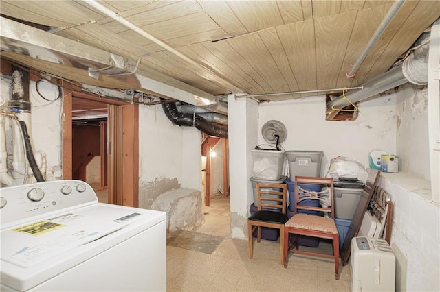 unfinished below grade area featuring wood ceiling and washer / clothes dryer