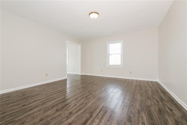 empty room featuring dark hardwood / wood-style flooring