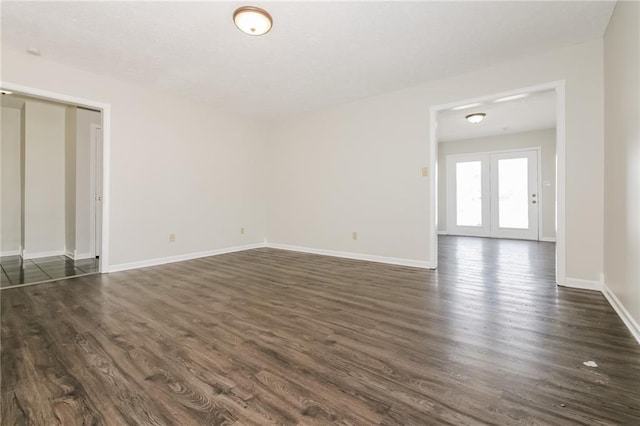 empty room with dark hardwood / wood-style floors