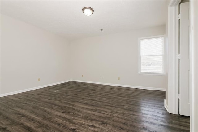 empty room featuring dark wood-type flooring