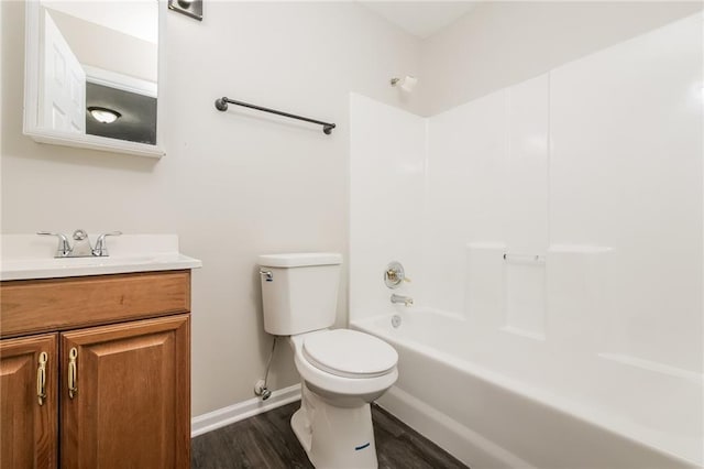 full bathroom featuring vanity, hardwood / wood-style floors, shower / bathtub combination, and toilet