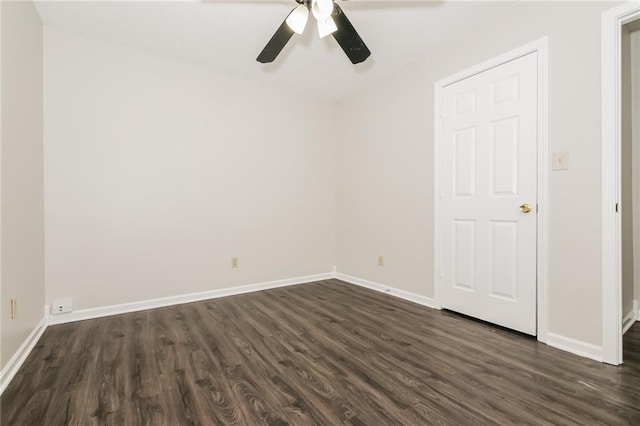 empty room with dark wood-type flooring and ceiling fan