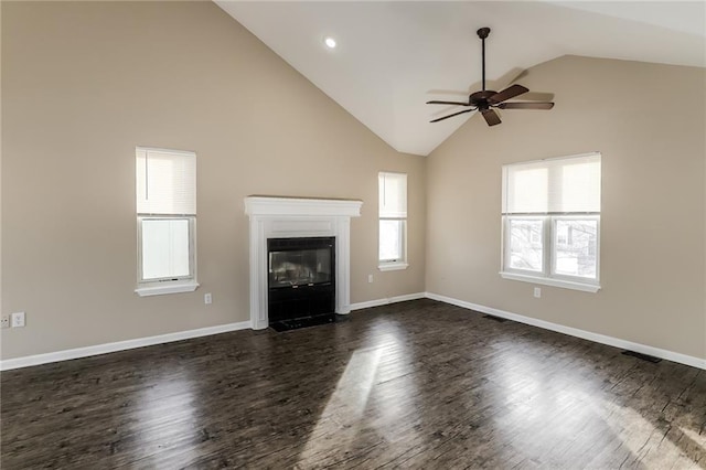 unfurnished living room with high vaulted ceiling, dark hardwood / wood-style floors, and ceiling fan