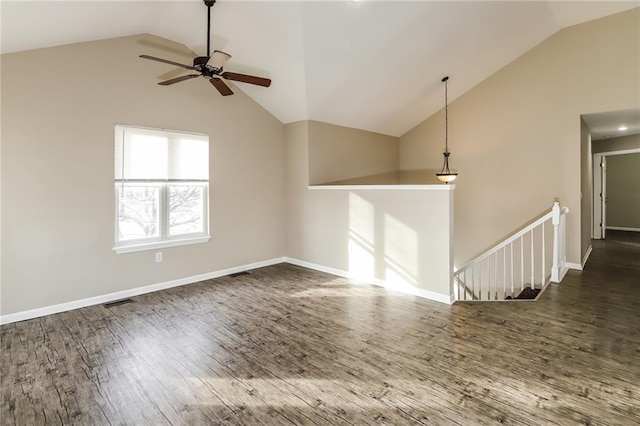 unfurnished living room with ceiling fan, lofted ceiling, and dark hardwood / wood-style flooring