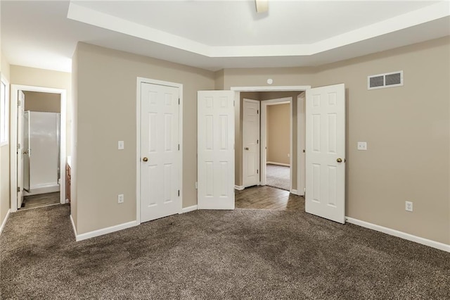 unfurnished bedroom featuring dark colored carpet