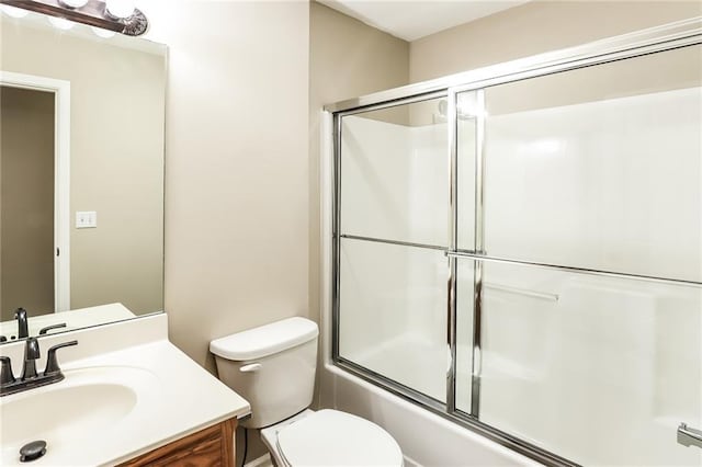 full bathroom with shower / bath combination with glass door, vanity, and toilet