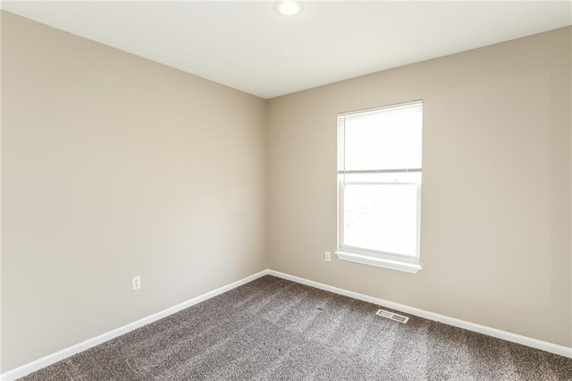 unfurnished room featuring carpet