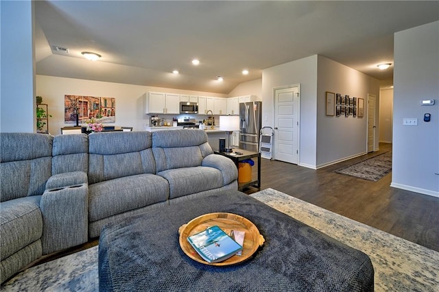 living room featuring vaulted ceiling and dark hardwood / wood-style floors