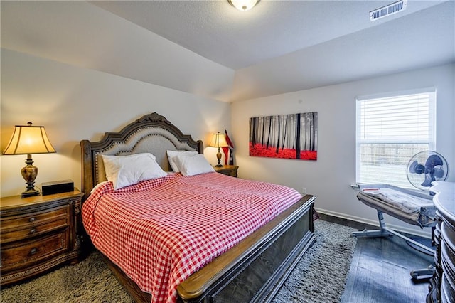 bedroom with dark hardwood / wood-style floors