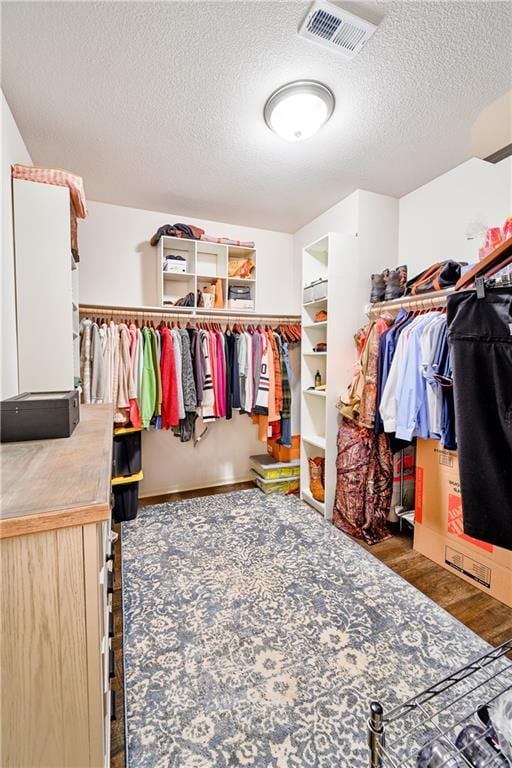 spacious closet with dark hardwood / wood-style floors